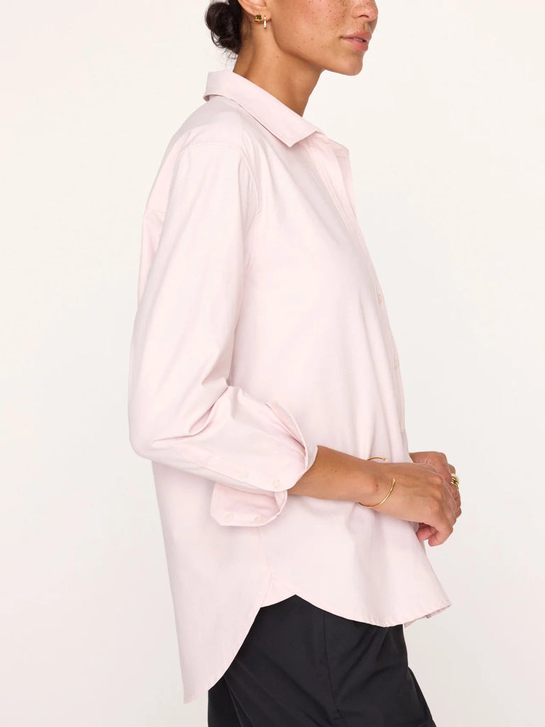 Side view of the Brochu Walker The Everyday shirt in rose quartz. Light pink women's button down worn on model with black leather pants.