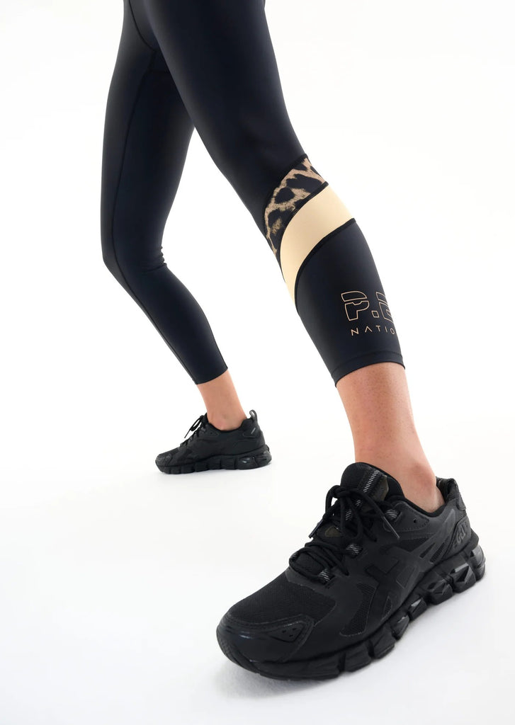 p.e. nation alignment legging in black model gold stripe colorblock detail photo and shoe